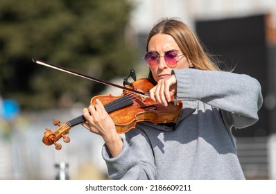 Sochi, Russia - February 22, 2022:A Woman Plays The Violin On The Street In A Resort Town.