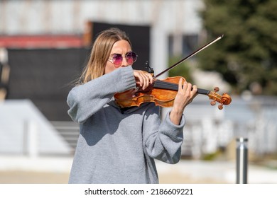 Sochi, Russia - February 22, 2022:A Woman Plays The Violin On The Street In A Resort Town.