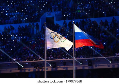 Sochi, RUSSIA - February 23, 2014: Olympic And Russian Flag At Closing Ceremony In Fisht Olympic Stadium At The Sochi 2014 Olympic Games