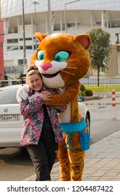 Sochi, Russia - January, 2017: Leopard, Symbol Of The Winter Olympic Games Hugs A Young Girl