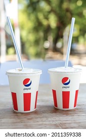   Sochi, Russia, July 16, 2021: Two Paper Cups With Pepsi Are On The Table In An Outdoor Cafe. Plastic Disposable Tableware.