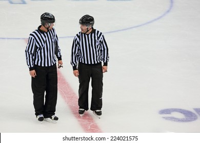 SOCHI, RUSSIA - MAR 12, 2014: Paralympic winter games. Shayba Arena, ice sledge hockey Italy-Sweden. Hockey referees discuss the game