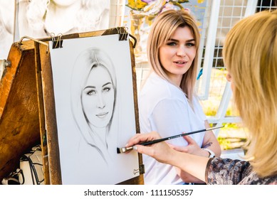 Sochi, Russia - May 30 2018: Street Artist Draws A Portrait Of A Girl