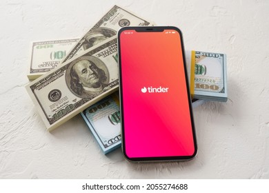 Sochi, Russia - October 1, 2021: iPhone 12 Pro Max  on money with  online Internet network service Tinder on the screen