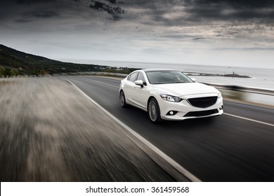 Sochi, Russia - September 7, 2014: Car Mazda Fast Speed Drive On Road At Sea Mountain Cloudy Sky Landscape