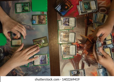SOCHI, RUSSIA-MAY 17, 2019: Two teenagers are playing in board game Magic The Gathering War of the Spark. Top view