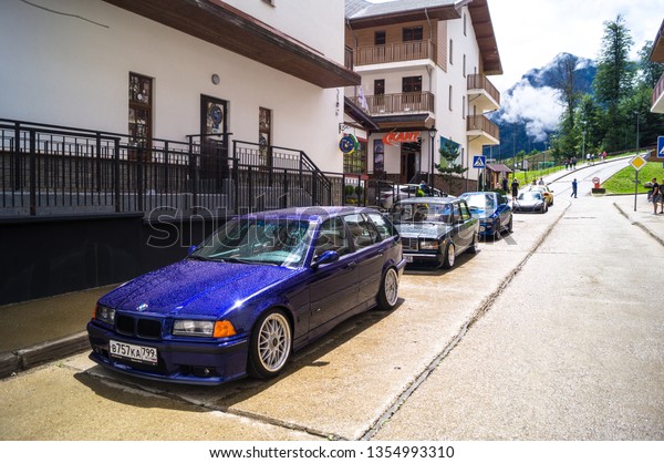 Sochi. Summer\
2018. Festivals Grounded Event. Blue BMW car with polished wheels,\
aerodynamic bodywork and air suspension installed in the parking\
lot to participate in the\
festival.
