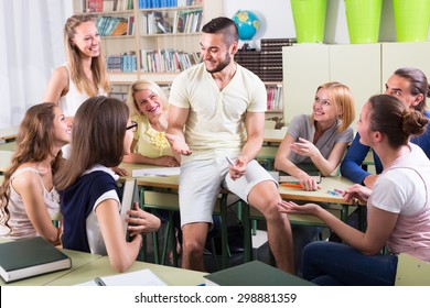 sociable adult students chatting while sitting in the room - Shutterstock ID 298881359
