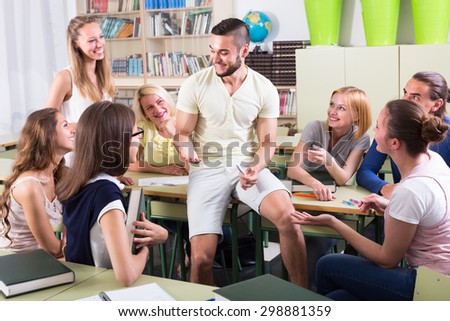 sociable adult students chatting while sitting in the room Stock fotó © 