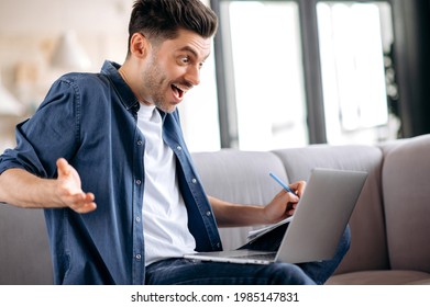 Sociable, friendly, emotional handsome caucasian guy sitting on the sofa in casual clothes, student talking during an online seminar, distance learning, group brainstorming, looking at screen, smiling - Shutterstock ID 1985147831