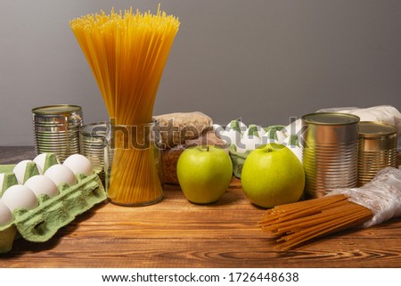 Social assistance from the state. The products of the first necessity. Non-perishable foods, spaghetti, canned food, apples, eggs, cereals, sugar. [[stock_photo]] © 