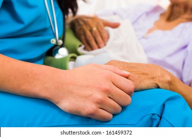 Social Care Provider Holding Senior Hands In Caring Attitude - Helping Elderly People.