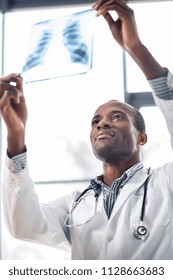 Social Community. Competent Medical Worker Pressing Lips While Staring At Roentgen, Raising Arms