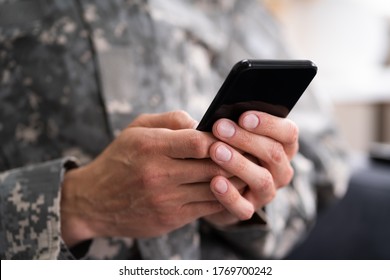 Social Cyber Warfare. Army Soldier Using Smart Phone - Powered by Shutterstock