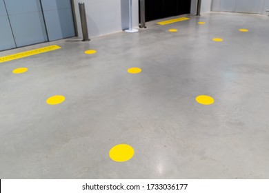 Social Distance Lift Line Up Marking With Round Yellow Sticker. Epidemic Protection Measures. Safe Shopping, Social Distancing Concept