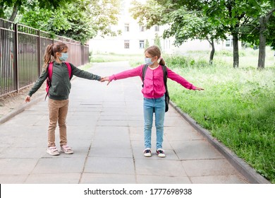 Social Distance In School Concept. Schoolchildren In Protective Masks Show Social Distance Of 6 Feet. Back To School During Coronavirus Pandemic. School Child Wearing Protective Face Mask In School.