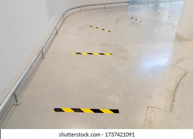 Social Distance Shopping Line Up Marking With Black Yellow Stripe Tape. Epidemic Protection Measures. Safe Shopping, Social Distancing Concept