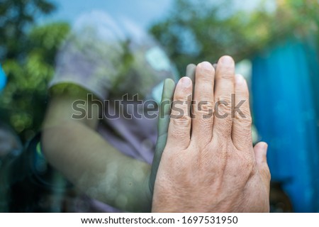 Social distancing among the family, the hand of the mother and daughter on a window plane, concept coronavirus, covid-19 pandemic.Work from home (WFH), Social distancing, Quarantine, 