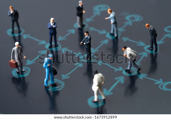 Social distancing, keep distance in public
society people to protect COVID-19 coronavirus outbreak spreading
concept, businessmen miniature keep distance away in the meeting
with distant measure.