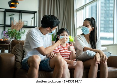 Social Distancing And New Normal Concept.strong Healthy Asian Family Wearing Surgical Protective Face Mask Stay Quarantined Together At Home.