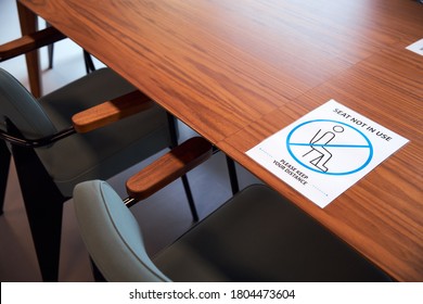 Social Distancing Sign In Office On Meeting Room Table.