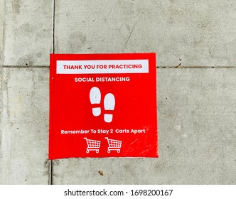 Social Distancing Sign On The Ground At Grocery Store Supermarket During COVID-19 Coronavirus Outbreak