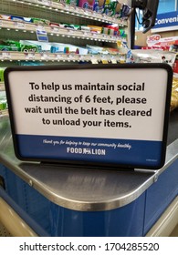 A Social Distancing Sign On Top Of A Grocery Store Checkout 
Concord NC 
April 14th 2020