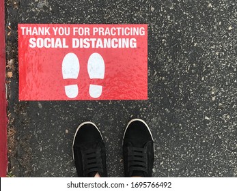 Social Distancing Sign For People Line Up In Front Of Grocery Store Or Retailer Store  To Reduce Risk Of Crowded Gathering In Store During Covid-19 Or Coronavirus Crisis 