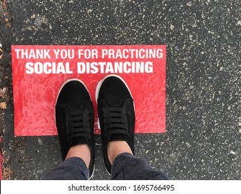 Social Distancing Sign For People Line Up In Front Of Grocery Store Or Retailer Store  To Reduce Risk Of Crowded Gathering In Store During Covid-19 Or Coronavirus Crisis 