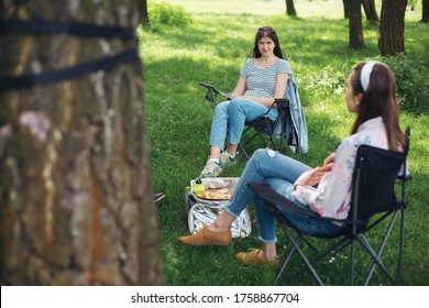 Social Distancing. Small Group Of Young Woman Enjoying Conversation At Picnic With Social Distance In Summer Park. Leisure Activity Together In New Normal, Safety Gatherings