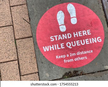 A Social Distancing Sticker On The Floor Warning People To Stay 2 Metres Apart