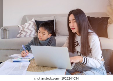 Social Distancing Student Concept, Junior High School Girl And Boy Do Homework At Home With Laptop. Education At Home. The School Is Closed During Covid-19 Asia Thailand