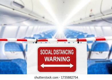 social distancing warning sign in airplane cabin against blurred passenger plane compartment background. Coronavirus disease COVID-19 new travel rules. Keep social distance banner concept - Powered by Shutterstock