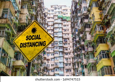 Social Distancing Warning Sign In Front Of A Crowded Public Housing Estate In Hong Kong. Concept Of Importance Of Social Distancing To Prevent COVID-19 Coronavirus Spread In A Densely Populated Area