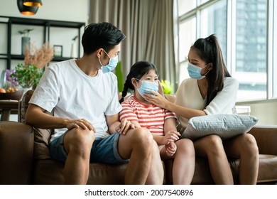 Social Distancing,cheerful Safty,insurance Family,stay At Home And New Normal Lifestyle Concept.Strong Healthy Asian Family Wearing Surgical Protective Face Mask Stay Quarantined Together At Home.