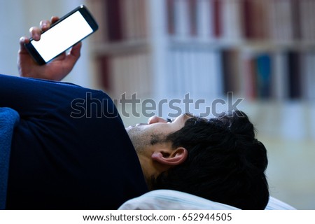 Similar – Image, Stock Photo Phone addiction. Man lying in bed with smartphone