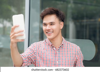 Social Media Communication. Casual Man Video Call Using Mobile Smart Phone Outdoors