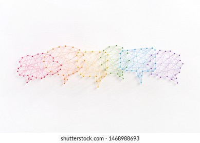 Social media concept. Network of pins and threads in the shape of many interconecting speech bubbles symbolising social dialog.