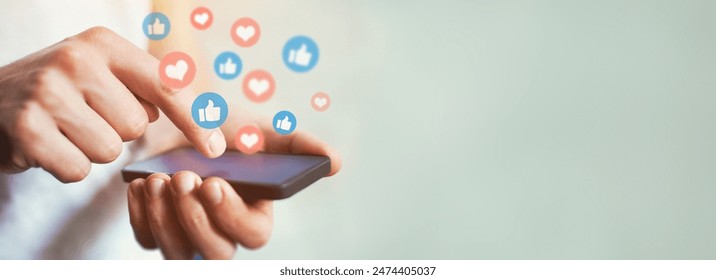 Social media and digital online communication concept, man using smartphone with likes icons on social media. Banner background. - Powered by Shutterstock