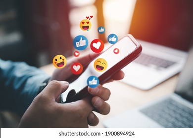 Social media and digital online concept, man using smart phone with Social media. The concept of living on vacation and playing social media. Social Distancing ,Working From Home concept. - Shutterstock ID 1900894924