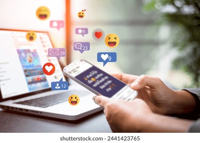 Social media and digital online concept. Person using a social media marketing on mobile phone with notification icons of like, message, comment and star above smartphone screen. Phone Social media. - Powered by Shutterstock