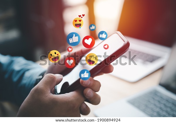 Social\
media and digital online concept, man using smart phone with Social\
media. The concept of living on vacation and playing social media.\
Social Distancing ,Working From Home\
concept.
