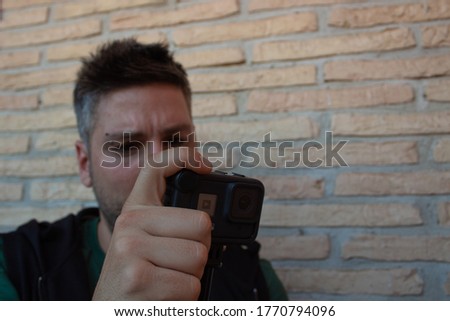 Social media influencer using camera. man reviewing recorded content.