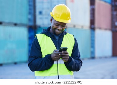 Social Media, Logistics And Employee Working In Shipping Typing On A Mobile App With Phone At A Port. Happy African Warehouse Man Reading An Email Or Communication On A Smartphone At Industrial Site