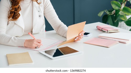 Social Media Marketing. SMM Expert At Work Scheduling Job. Woman Writing. Office Supplies And Technology Tools At Hand.