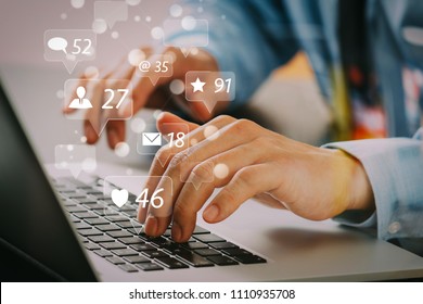 Social media and Marketing virtual icons screen concept.close up of businessman typing keyboard with laptop computer on wooden desk in modern office    