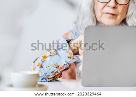 Social media networking background with a senior woman working on a laptop