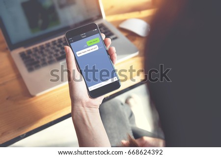 Social network, Chating and messaging concept, Closeup woman hand holding smart phone, Mock up to screen chat box.