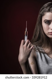 The Social Problem. Young Unhappy Woman Holding A Syringe To Drug Use