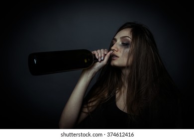 The Social Problem. Young Unhappy Woman Drinking Alcohol From A Bottle